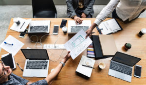 Overhead shot of three people planning and sharing notes