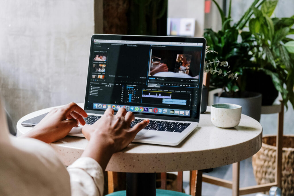 A digital content creator editing their work on a laptop computer.